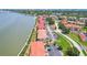 Waterfront condos with red roofs, offer convenient parking, landscaping, and beautiful bay access for boating and recreational activities at 446 Bouchelle Dr # 103, New Smyrna Beach, FL 32169