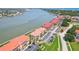 Red-roofed condos feature bay views, waterfront access, ample parking, and landscaping for luxury coastal living at 446 Bouchelle Dr # 103, New Smyrna Beach, FL 32169