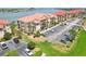 Aerial view of condos with terracotta roofs and parking at 446 Bouchelle Dr # 103, New Smyrna Beach, FL 32169