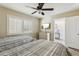 A guest bedroom with 2 beds, dresser, ceiling fan, and natural light from the window at 446 Bouchelle Dr # 103, New Smyrna Beach, FL 32169