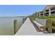 Scenic boardwalk with a bench provides beautiful bay views and a tranquil spot for relaxation by the waterfront condos at 446 Bouchelle Dr # 103, New Smyrna Beach, FL 32169
