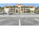 Attractive multi-level condominium building with ample parking and tropical landscaping at 446 Bouchelle Dr # 103, New Smyrna Beach, FL 32169