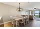 Chic dining area with modern lighting and seamless flow to the living room at 446 Bouchelle Dr # 103, New Smyrna Beach, FL 32169