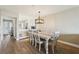 Bright dining area with wood floors and modern light fixture open to the kitchen at 446 Bouchelle Dr # 103, New Smyrna Beach, FL 32169