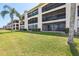 A three-story condominium building with screened balconies and well-maintained grounds at 446 Bouchelle Dr # 103, New Smyrna Beach, FL 32169