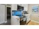 Updated kitchen with stainless steel stove, microwave, and white cabinets at 446 Bouchelle Dr # 103, New Smyrna Beach, FL 32169