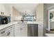 Open kitchen with quartz countertops, stainless steel appliances, and views to the dining area at 446 Bouchelle Dr # 103, New Smyrna Beach, FL 32169