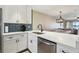 Modern kitchen featuring white cabinets, stainless steel appliances, and quartz countertops at 446 Bouchelle Dr # 103, New Smyrna Beach, FL 32169