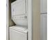 In-unit, stackable laundry machines tucked away in a closet at 446 Bouchelle Dr # 103, New Smyrna Beach, FL 32169