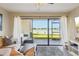 Waterfront view from the open-concept living space with cozy seating at 446 Bouchelle Dr # 103, New Smyrna Beach, FL 32169