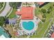 Aerial view showcasing a resort-style pool with a unique heart shape and community recreational facilities at 446 Bouchelle Dr # 103, New Smyrna Beach, FL 32169