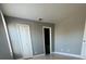 This bedroom features neutral paint and a closet for storage at 4772 Walden Cir # 228, Orlando, FL 32811