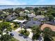 Stunning aerial view of homes, featuring lush landscaping and a glimpse of the serene lake in the background at 5100 La Croix Ave, Belle Isle, FL 32812
