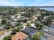 Charming aerial captures a vibrant neighborhood, showcasing lush greenery and a glimpse of the lake at 5100 La Croix Ave, Belle Isle, FL 32812