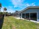 Expansive backyard features a screened-in pool area, open green space, and mature trees at 5100 La Croix Ave, Belle Isle, FL 32812
