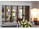 Close-up of the bar area featuring glassware, wine rack, and decorative mirrored panels at 5100 La Croix Ave, Belle Isle, FL 32812