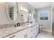 Bathroom featuring double sinks, granite countertop, and contemporary lighting at 5100 La Croix Ave, Belle Isle, FL 32812