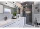 Modern bathroom featuring double vanity, glass enclosed shower with stylish tile, and contemporary fixtures at 5100 La Croix Ave, Belle Isle, FL 32812