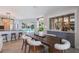 Dining room with a bar area, view of the pool, wood table, and stylish seating at 5100 La Croix Ave, Belle Isle, FL 32812