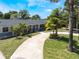 Charming single story home featuring a well-manicured lawn and a welcoming driveway at 5100 La Croix Ave, Belle Isle, FL 32812