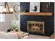 Close-up of the living room's black brick fireplace with decorative mantle at 5100 La Croix Ave, Belle Isle, FL 32812