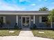 Close up of the front entrance highlighting the glass doors and decorative columns at 5100 La Croix Ave, Belle Isle, FL 32812