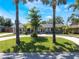 Charming single-story home with a well-manicured lawn and circular driveway framed by mature palm trees at 5100 La Croix Ave, Belle Isle, FL 32812
