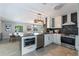 Modern kitchen with stainless steel appliances and breakfast bar connecting to dining area at 5100 La Croix Ave, Belle Isle, FL 32812