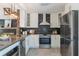 Bright kitchen featuring stainless steel appliances, white cabinets, and modern finishes at 5100 La Croix Ave, Belle Isle, FL 32812