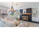 Cozy living room featuring a striking black brick fireplace and natural light at 5100 La Croix Ave, Belle Isle, FL 32812