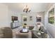 Spacious living room featuring elegant chandelier, modern entertainment center, and comfortable seating at 5100 La Croix Ave, Belle Isle, FL 32812