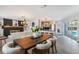Open living space with dining area, kitchen, and a view of the pool at 5100 La Croix Ave, Belle Isle, FL 32812