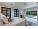 Charming bedroom with pool view, stylish rug, and modern sliding door closets at 5100 La Croix Ave, Belle Isle, FL 32812
