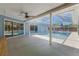 Spacious patio with a ceiling fan, sliding doors to the screened-in pool, and abundant natural light at 5100 La Croix Ave, Belle Isle, FL 32812