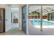 View of the pool from inside the home showing a transition to the outdoors at 5100 La Croix Ave, Belle Isle, FL 32812