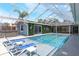 Outdoor pool with a spa surrounded by a screened enclosure with outdoor seating at 5100 La Croix Ave, Belle Isle, FL 32812