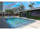 Relax in the screened-in pool area with lush greenery and outdoor entertainment options at 5100 La Croix Ave, Belle Isle, FL 32812