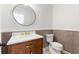 Stylish powder room with modern fixtures, decorative mirror and elegant vanity at 5100 La Croix Ave, Belle Isle, FL 32812