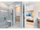 Bright bathroom with a glass shower, toilet area, and an open view into the Primary bedroom at 5156 Gardenrow Dr, St Cloud, FL 34772