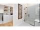 Modern bathroom featuring a glass-enclosed shower and a glimpse into the walk-in closet at 5156 Gardenrow Dr, St Cloud, FL 34772