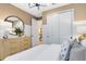 Bedroom with a decorative dresser and a large mirror, along with white closet doors for ample storage at 5156 Gardenrow Dr, St Cloud, FL 34772