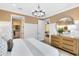 Well-lit bedroom showcasing a chandelier, and a view leading into the living room at 5156 Gardenrow Dr, St Cloud, FL 34772