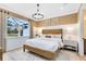 Comfortable bedroom featuring a large window, light fixture and neutral decor at 5156 Gardenrow Dr, St Cloud, FL 34772