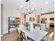 Open dining area featuring modern chandelier, leading into kitchen and living room with lots of natural light at 5156 Gardenrow Dr, St Cloud, FL 34772