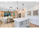 Open-concept kitchen and dining area featuring a center island, modern lighting, and views of the living space at 5156 Gardenrow Dr, St Cloud, FL 34772