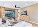Inviting living room featuring a ceiling fan and sliding glass doors leading to a pool area at 5156 Gardenrow Dr, St Cloud, FL 34772