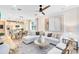Spacious living room with modern decor, a large sectional sofa, and a view into the kitchen at 5156 Gardenrow Dr, St Cloud, FL 34772