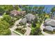 Majestic home with lush landscaping, mature palms, and a paver circular driveway on the lake at 5550 Osprey Isle Ln, Orlando, FL 32819