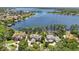 Lakefront homes with manicured lawns, mature trees, and scenic water views at 5550 Osprey Isle Ln, Orlando, FL 32819