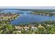 Waterfront community with lush trees providing a scenic backdrop to serene water views at 5550 Osprey Isle Ln, Orlando, FL 32819